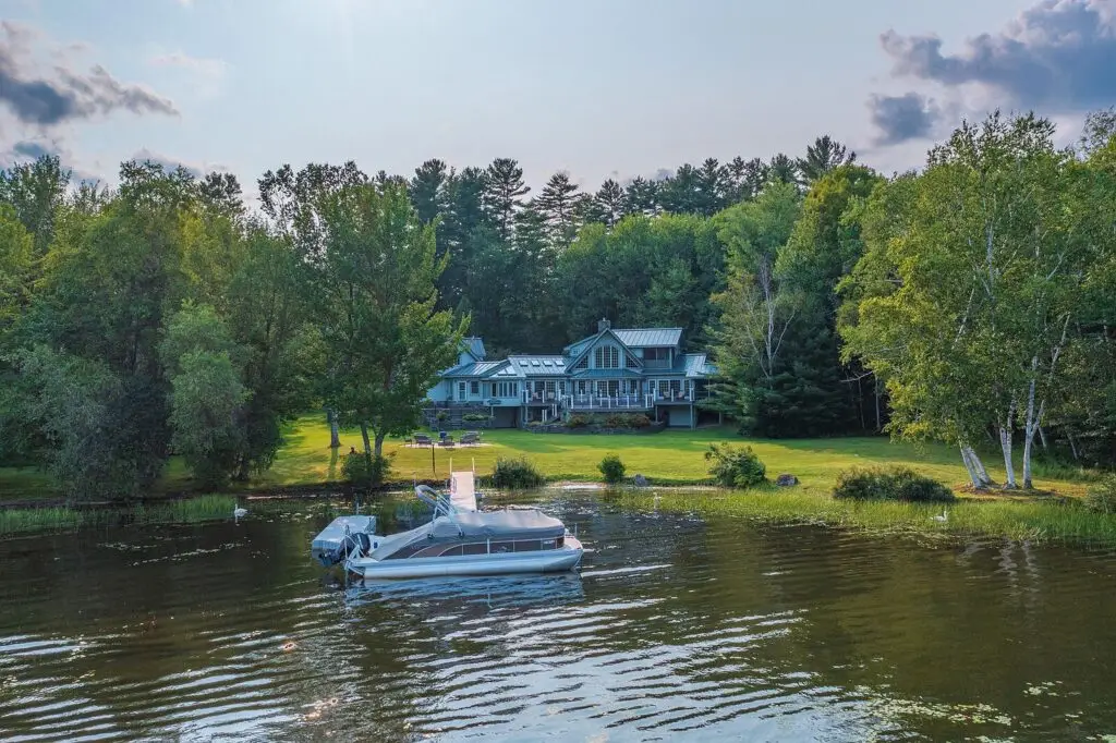 Wilson Lake view from the lawn with the private dock and pontoon boat, Wilton Maine