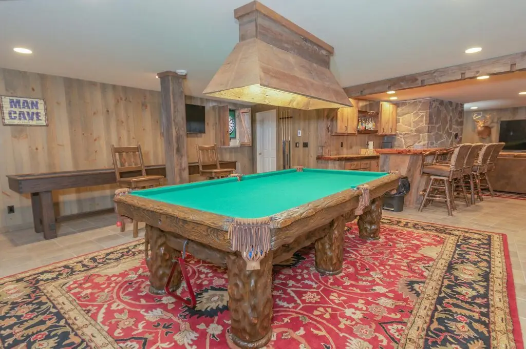 Lower-level game room with the custom Amish log pool table