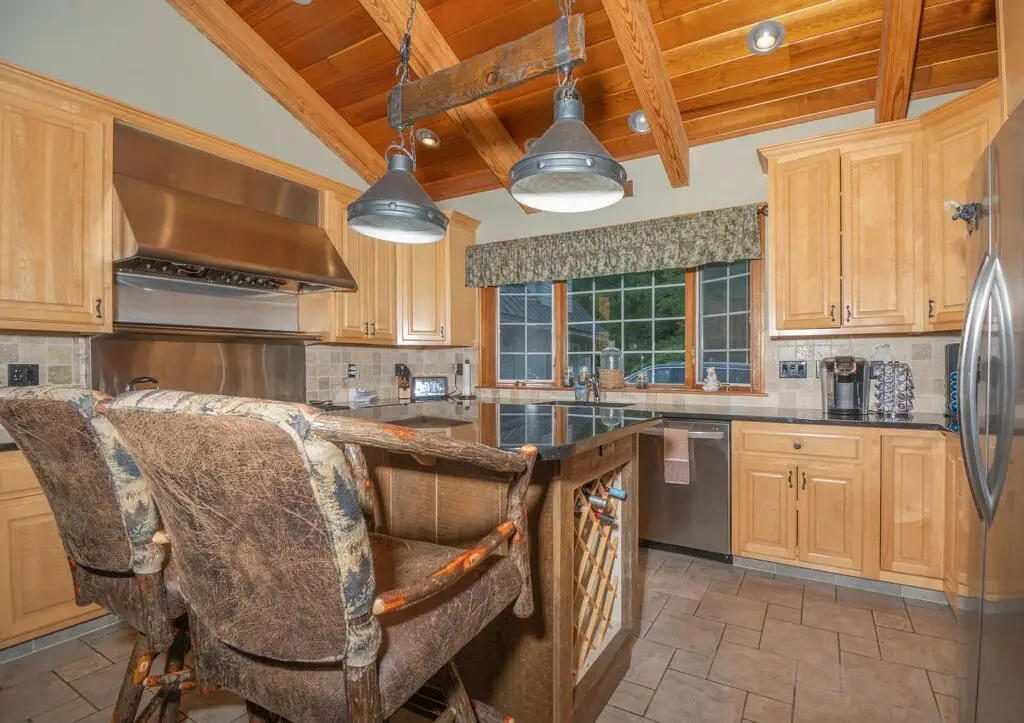 Kitchen island with built-in wine rack and natural wood cabinetry