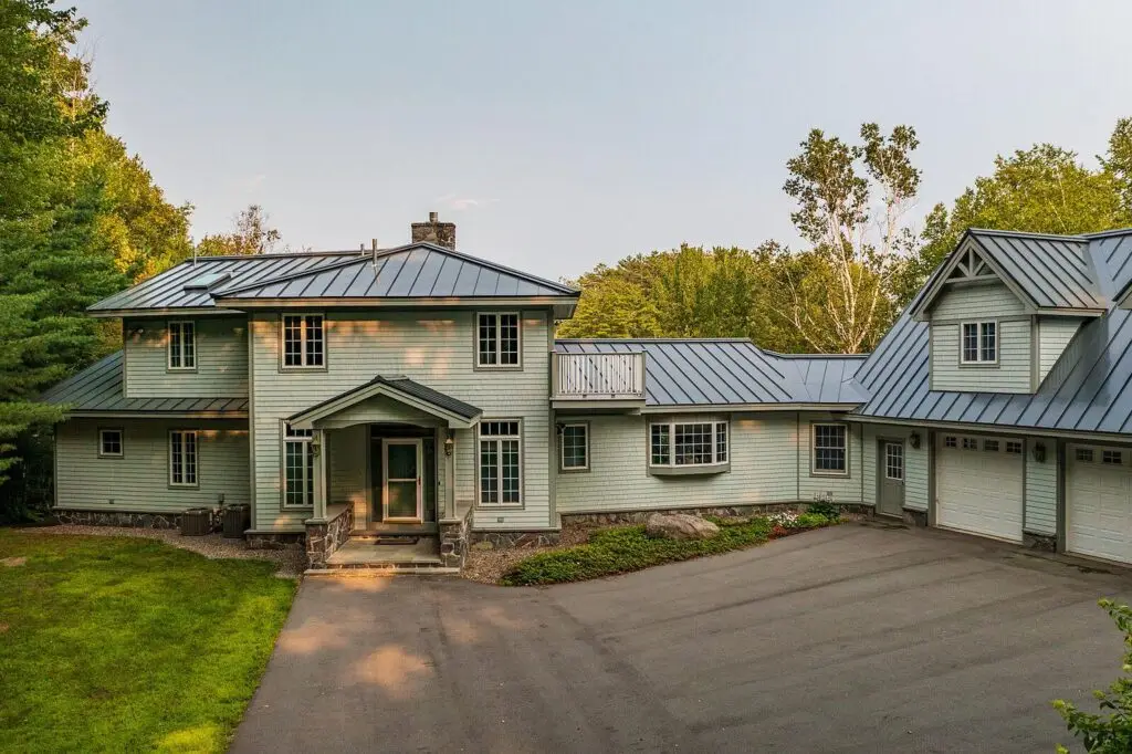 Front of the house with driveway and attached three-car garage