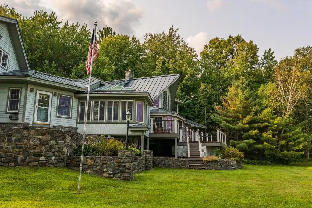 Back of the house showing the sunroom and deck over the lake