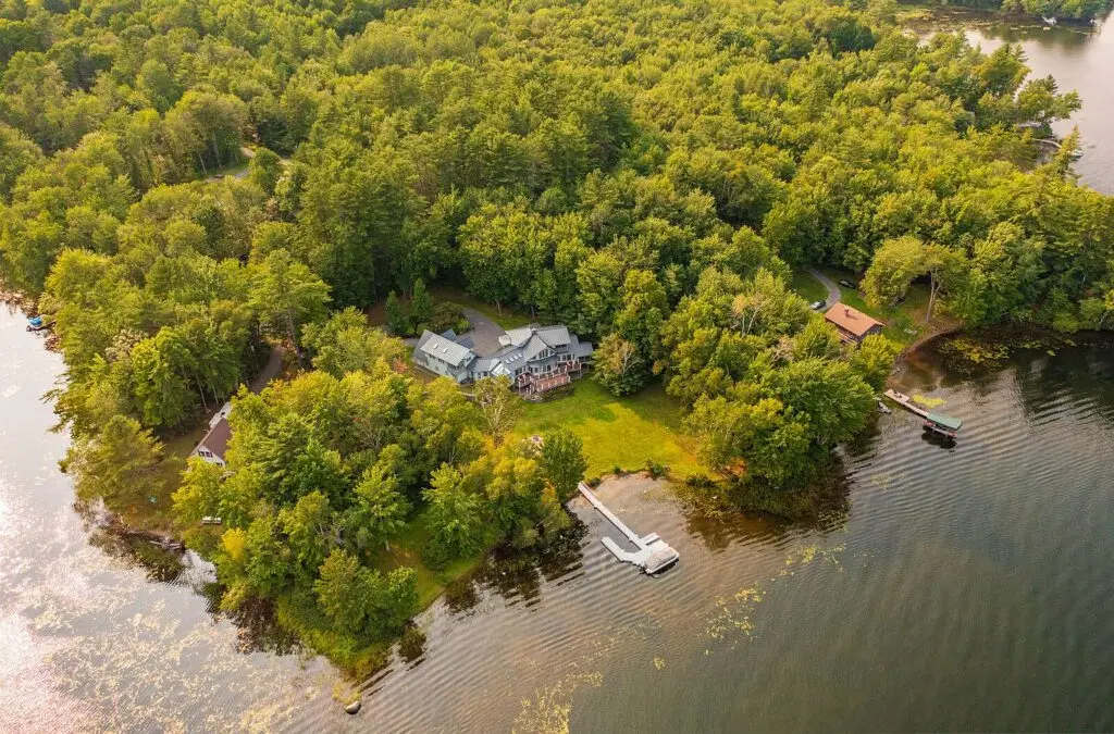 Aerial view of the property, private dock and pontoon boat on Wilson Lake