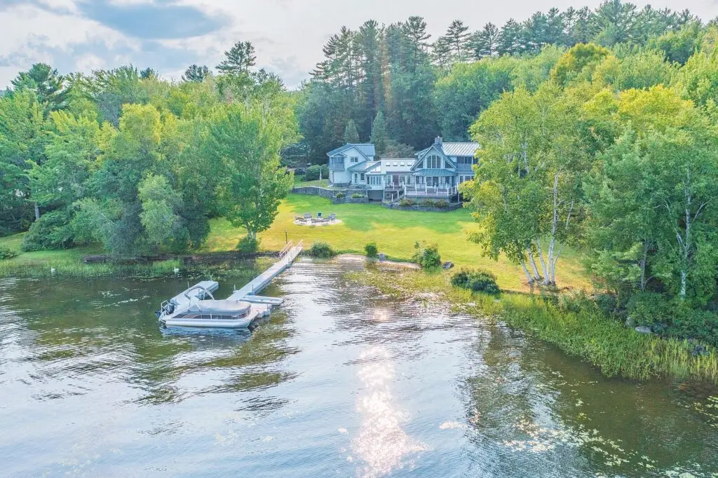 Aerial of the lakefront house with pontoon boat at the dock