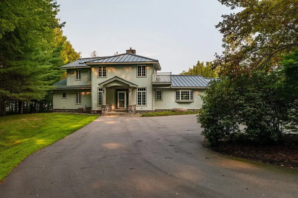 Front of the house framed by trees along the driveway