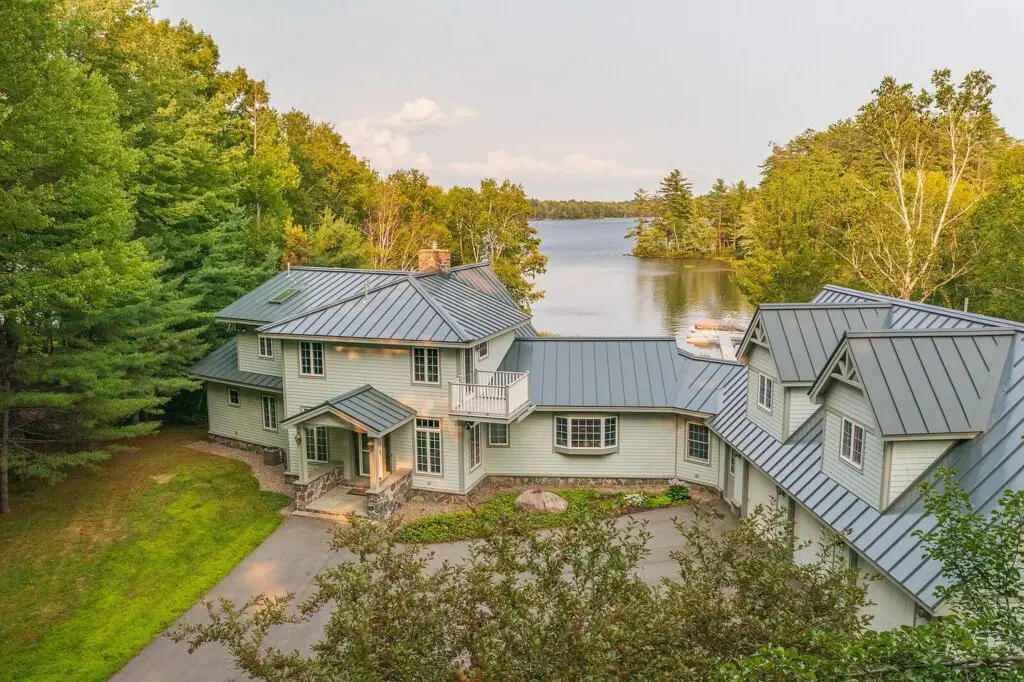 Aerial view of the front of the house and garage with the lake behind